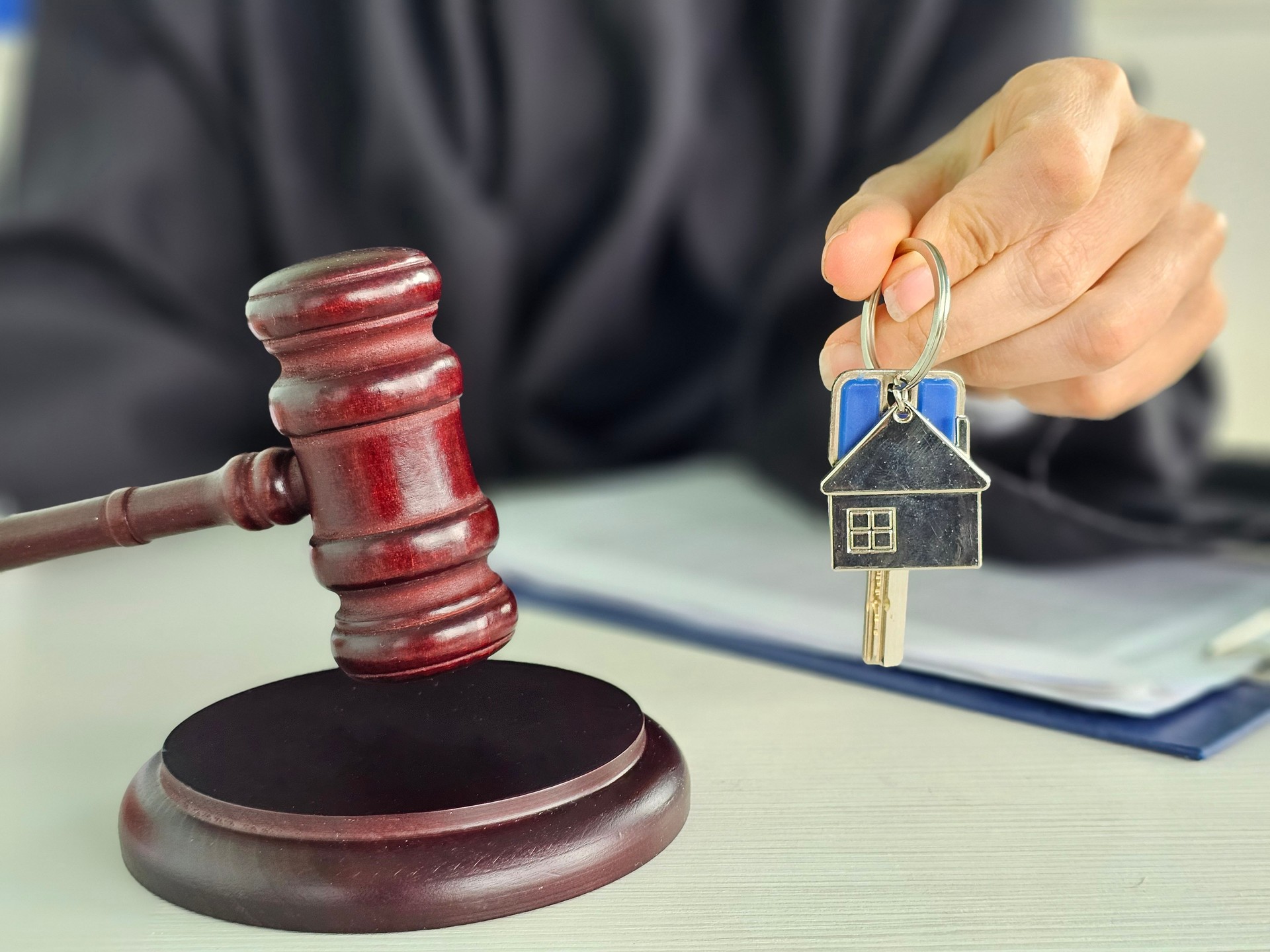 Judges wooden gavel and house keys. Selling real estate auction concept. Court decision and problem with selling real estate
